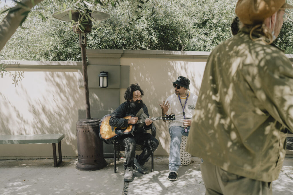 Demetrius (who goes by "Demo”) plays the guitar for Herman, a program coordinator at The Center in Hollywood, a community space where anyone experiencing homelessness can feel welcome and safe while receiving services .